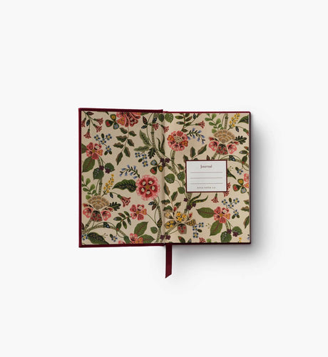 A mini hardcover journal, embroidered with delicate Gracie blooms and gold accents. Inside, find 240 blank, unlined pages and a ribbon bookmark.
