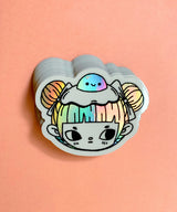 "Egg Buns" Vinyl Sticker made from Hannakin illustration with holographic accents (hair and egg yolk) and shiny gloss finish.

Made from a durable waterproof vinyl with a matte laminate that protects it from scratching, rain and sunlight.