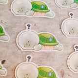 This is a glossy vinyl die-cut paper sticker with holographic features, illustrated and made in-house by me. It's waterproof and ideal for decorating hard surfaces like laptops, water bottles, and phone cases, adding a cute touch to your belongings.&nbsp;

Material: premium glossy waterproof vinyl