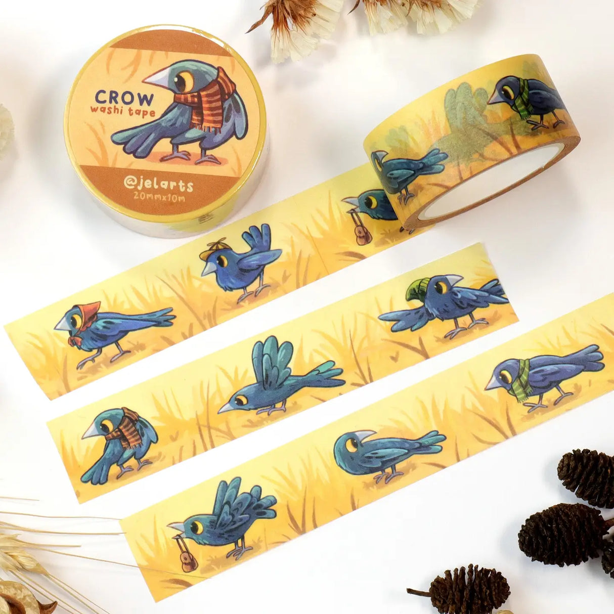 A bunch of crows wearing various accessories, on a roll of washi tape!

20mm wide x 10m length
Great for decorating journal spreads, sketchbooks, scrapbooks, and more!
Plastic wrapped with a label on one side