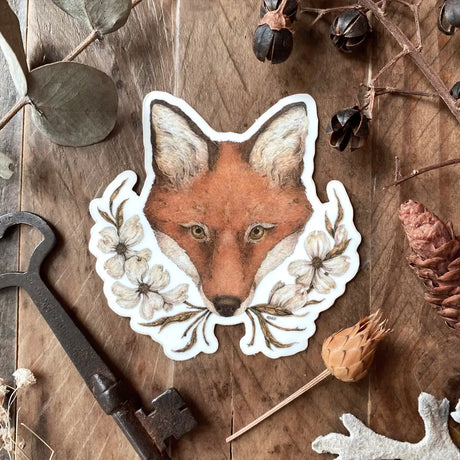 Vinyl semi-transparent sticker of an antique sewing machine and rose, illustrated by Jessica Roux.

The background of the sticker is transparent, but the sewing machine and rose are opaque.

Sticker measures approximately 2.6" x 2.1" and is glossy.