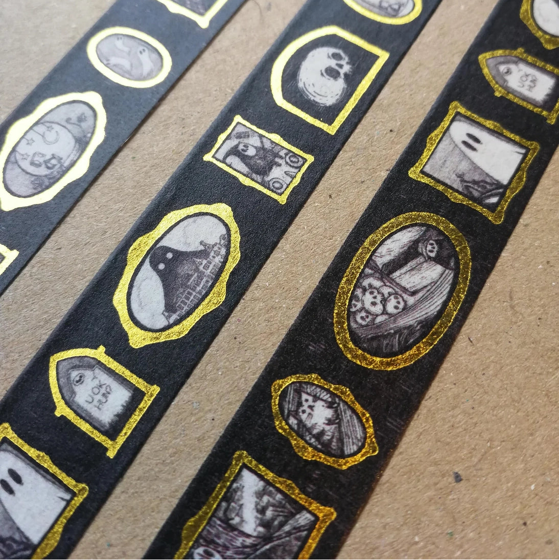 Turn every surface into a tiny gallery with this washi tape featuring tiny Jon Turner artworks in shiny gold frames, an array of little robots, ghosts and other spooky oddities. Perfect for spooky journalling or curious correspondence.

Two designs available, with each tape featuring 16 miniature masterpieces in a repeating pattern. Each roll measures approximately 15mm wide, and the roll is 10m long; they are cello wrapped and decorated with branded stickers on either side.



15mm wide
10m length