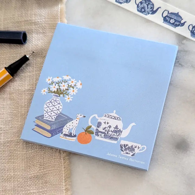 A simple sticky notepad for jotting down to-do's, grocery lists, or whatever you need to remember. Illustrated with a willow pattern tea set, Staffordsire dalmatian figurine, and vase of daisies.