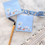 A simple sticky notepad for jotting down to-do's, grocery lists, or whatever you need to remember. Illustrated with a willow pattern tea set, Staffordsire dalmatian figurine, and vase of daisies.