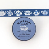 This tea themed washi tape is made from my original illustrations, and it features a continuous parade of different styles of blue and white teapots on a blue background.