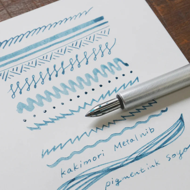 The stainless steel nib was born from a desire for a durable and practical dip pen nib. Enjoy a variety of line widths from fine to broad by tilting the nib at different angles. Fits most nib holders as well as those from our range.

The nib was designed by Yuto Yamazaki of Kuramae-based design studio Alloy. The nib tip has been rounded and polished with meticulous care, providing a remarkably smooth writing experience that defies expectation. Perfected over many iterations, the innovative nib is like no ot