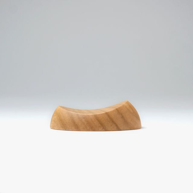 A pen rest that enhances the moments between writing. Designed to hold any pen without the need for precise placement, it blends effortlessly into your desk space with a subtle but assured presence. Enjoy the rich texture and wood grain of Japanese cherry.

Designed for stability to ensure your pens and surfaces are protected from accidental movement or damage. The pen rest comfortably holds two to three slender pens.

Use and Care:

To prevent distortion and discolouration, avoid soaking in water, sudden t