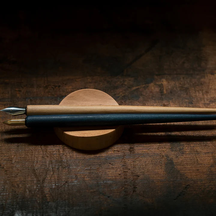 A pen rest that enhances the moments between writing. Designed to hold any pen without the need for precise placement, it blends effortlessly into your desk space with a subtle but assured presence. Enjoy the rich texture and wood grain of Japanese cherry.

Designed for stability to ensure your pens and surfaces are protected from accidental movement or damage. The pen rest comfortably holds two to three slender pens.

Use and Care:

To prevent distortion and discolouration, avoid soaking in water, sudden t