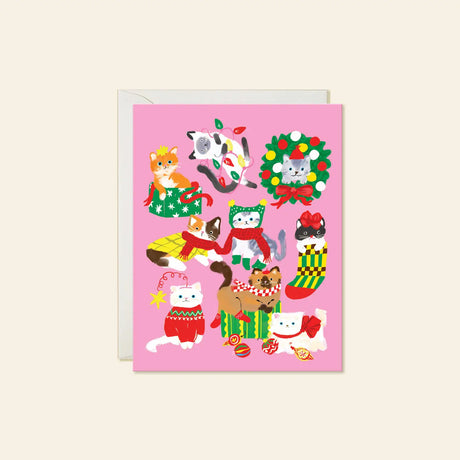 Karen Schipper Greeting Card - Christmas Cats

A pink holiday scene packed with cats in sweaters, scarves, stockings, bows, lights, and gift boxes makes this design feel instantly merry. This hand-illustrated Christmas Cats holiday card brings together playful feline characters and festive details, making it a cheerful pick for cat lovers and those who want a Christmas card with extra personality. 

A2 folded card, 4.25" W × 5.5" L
Printed in full color on FSC® certified white cover paper
Blank interior
Sin