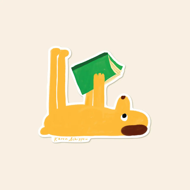 Book stickers are always a win in checkout displays — and this one is especially hard to resist. Reading Dog Sticker features a bright yellow pup stretched out on its back with a green book held high, making it an instantly recognizable book sticker for readers who love a little humor.

Made from matte-coated, waterproof vinyl, it’s durable enough for laptops, planners, water bottles, and more. It’s an easy impulse add-on for cat people, best friends, and shoppers looking for a small but meaningful gift.

M