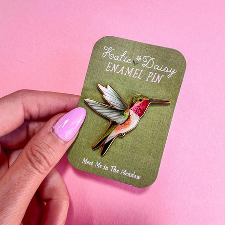 Hummingbird Enamel Pin by Katie Daisy

A tiny treasure to pin on your jacket, tote, or favorite old flannel—each one a little love letter to country delights, small joys, and the art of noticing.