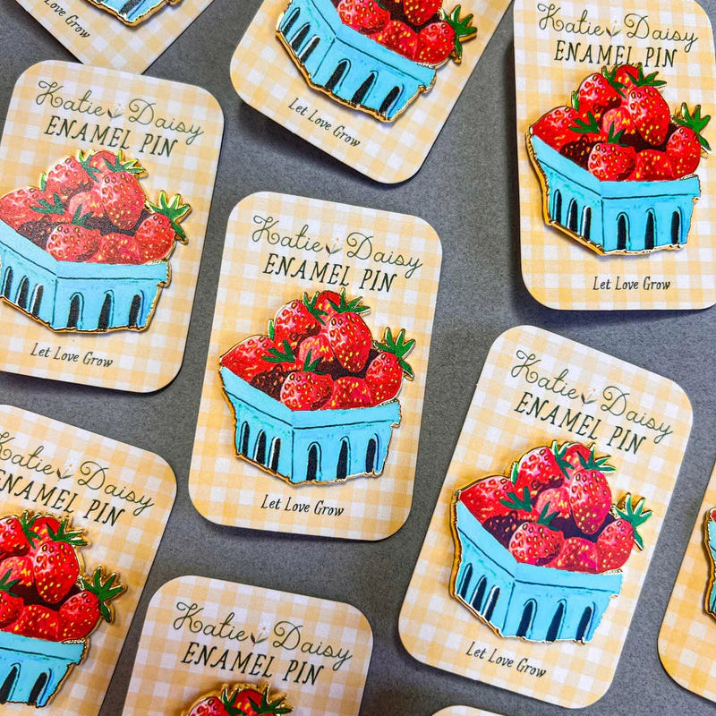Strawberries Enamel Pin by Katie Daisy

A tiny treasure to pin on your jacket, tote, or favorite old flannel—each one a little love letter to country delights, small joys, and the art of noticing.
