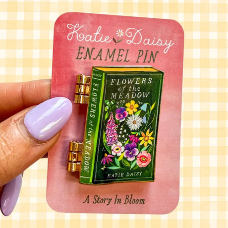 A tiny treasure for book lovers, wildflower wanderers, and collectors of small beautiful things.
This interactive enamel pin features a working hinge that allows the miniature book to open and close, revealing a hidden floral spread inside. Inspired by beloved vintage books and meadow blooms, it’s a little story you can wear on your jacket, tote, sweater, or favorite old flannel.

Details:
• 1.75” on the longest side
• Interactive hinged design that opens like a tiny book
• Gold-plated finish
• Rich, detail