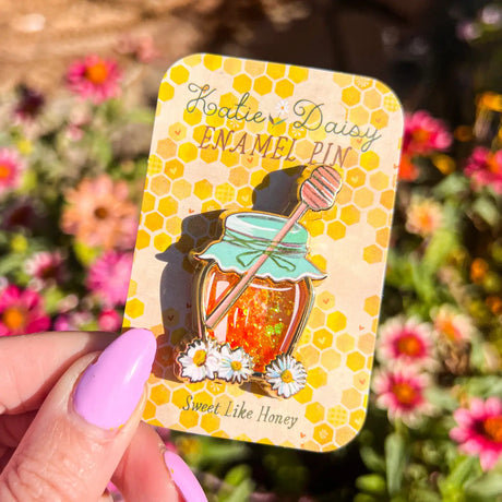 A tiny treasure to pin on your jacket, tote, or favorite old flannel—each one a little love letter to country delights, small joys, and the art of noticing.

Details:

Liquid glitter that catches the light like real honey&nbsp;
Gold-plated finish&nbsp;
Single post so it stays put&nbsp;
Packaged on a sweet little honeycomb card


Designed with love in my Oregon studio. Manufactured in China.
Collect them all or gift one to a kindred spirit. 🌸