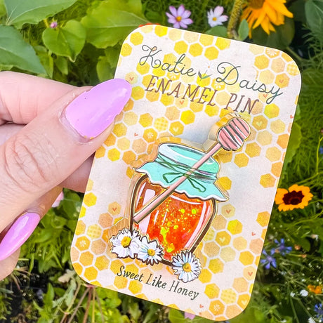 A tiny treasure to pin on your jacket, tote, or favorite old flannel—each one a little love letter to country delights, small joys, and the art of noticing.

Details:

Liquid glitter that catches the light like real honey&nbsp;
Gold-plated finish&nbsp;
Single post so it stays put&nbsp;
Packaged on a sweet little honeycomb card


Designed with love in my Oregon studio. Manufactured in China.
Collect them all or gift one to a kindred spirit. 🌸