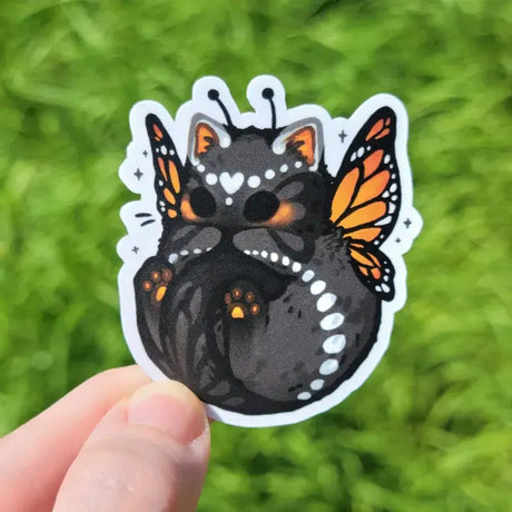 2.3" matte vinyl sticker featuring a sweet monarch butterfly kitty.

Matte laminated vinyl sticker
Waterproof, UV- and scratch-resistant
Features original, 100% hand-drawn art
Actual color may vary due to differences in lighting, device screen settings, etc.