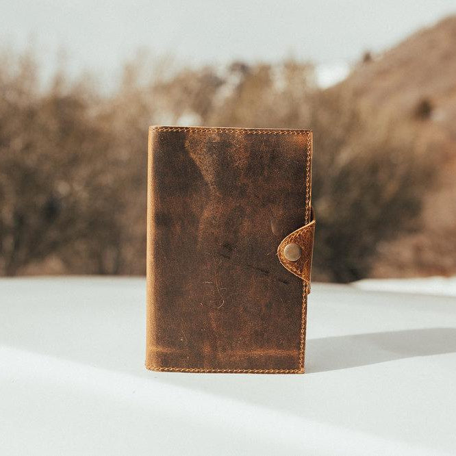 Kodiak Leather Drifter Leather Journal

The Drifter Leather Journal is designed for travelers, writers, and creatives who appreciate quality craftsmanship and timeless style. Made from top-grain leather, this beautifully crafted journal features a secure snap-button closure and handmade artisan paper, making it an ideal gift for adventurers and homebodies alike.

With 210 blank pages and a refillable design, it’s perfect for capturing thoughts, sketches, or travel memories. Measuring 7” x 5” x 2.5”, the Dri
