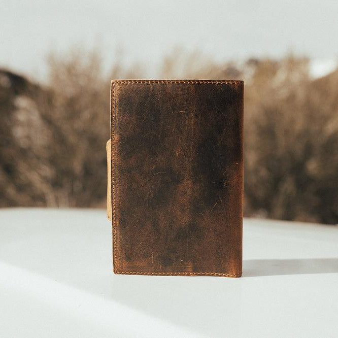 Kodiak Leather Drifter Leather Journal

The Drifter Leather Journal is designed for travelers, writers, and creatives who appreciate quality craftsmanship and timeless style. Made from top-grain leather, this beautifully crafted journal features a secure snap-button closure and handmade artisan paper, making it an ideal gift for adventurers and homebodies alike.

With 210 blank pages and a refillable design, it’s perfect for capturing thoughts, sketches, or travel memories. Measuring 7” x 5” x 2.5”, the Dri