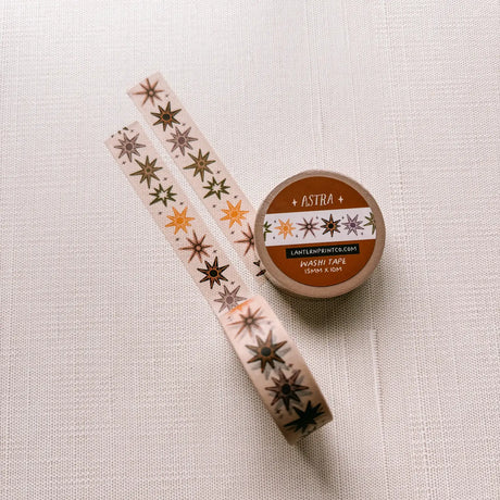 Removable Washi craft tape for journaling and gift wrapping; featuring whimsical celestial stars on a cream background.

15mm x 10m
Shrink wrap packaging with label