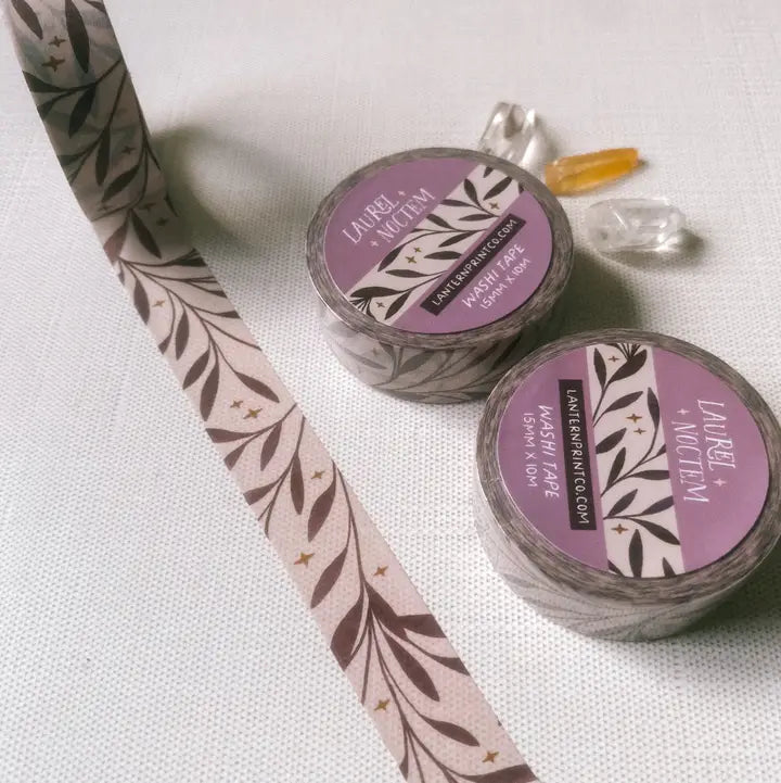 Removable Washi craft tape for journaling and gift wrapping; featuring laurel leaves and stars.

15mm x 10m
Shrink wrap packaging with label