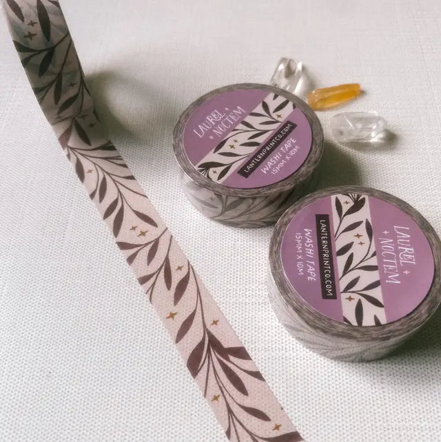 Removable Washi craft tape for journaling and gift wrapping; featuring laurel leaves and stars.

15mm x 10m
Shrink wrap packaging with label