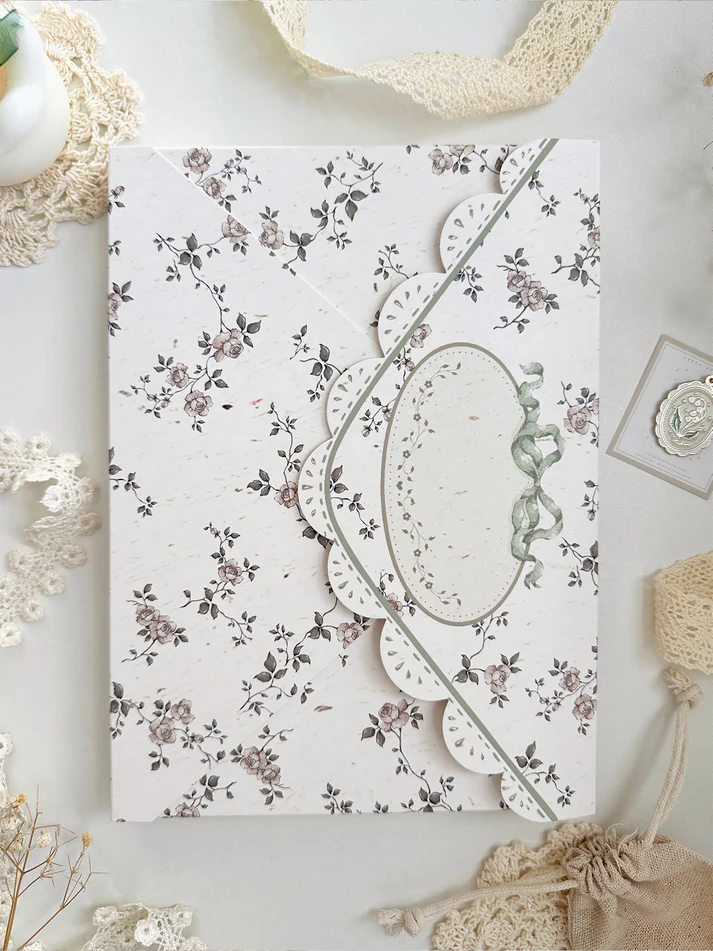 lily&nbsp;of the valley fabric notebook cover. sewn together with careful craftsmanship. lined with lace ruffles for that extra romantic, cottage-core, fairytale touch. meant to protect your notebooks &amp; a keepsake for your beloved stationery :)

♡ floral linen pattern with ruffle lace edging &amp; lily of the valley embroidery

♡ lace ribbon enclosure to help keep your notebooks closed

♡ 7 pockets total (left sleeve: 5 pockets | right sleeve: 2 pockets)

♡ x1 lace ribbon book mark with gold bow pendant