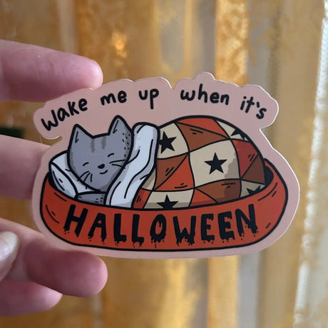A gray sleeps in a little bed with a blanket and pillow, dreaming of October days.

3in wide
Waterproof
Matte Finish