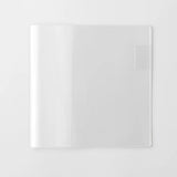 A transparent cover that fits snugly around your MD Notebook

This is a special cover that gently wraps your MD Notebook. The transparent cover protects the notebook from dirt without ruining its appearance.
It subtly protects your notebook from water and dirt without interfering with its characteristics. If you put the cover on with the glassine paper still wrapped around it, the inorganic feel of the vinyl will be softened.
Because it is transparent, you can enjoy the cover design, illustrations, and writ