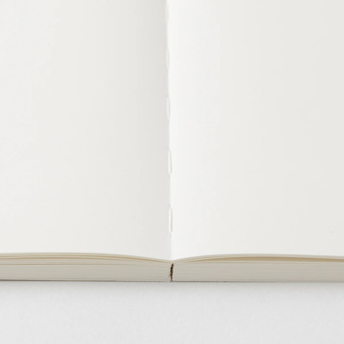 Crafted in Japan, this minimalist notebook is designed to enhance your writing experience. Inside, you'll find the high-quality Midori Diary (MD) paper, first developed in 1960 and refined ever since. Midori has rigorously tested this paper with various writing instruments to ensure quality, checking for ink feathering or bleeding, drying time, the smoothness of pen tips on the surface, and the tactile feel. The result is a paper that resists bleeding and feathering and is fountain-pen friendly, ensuring a 