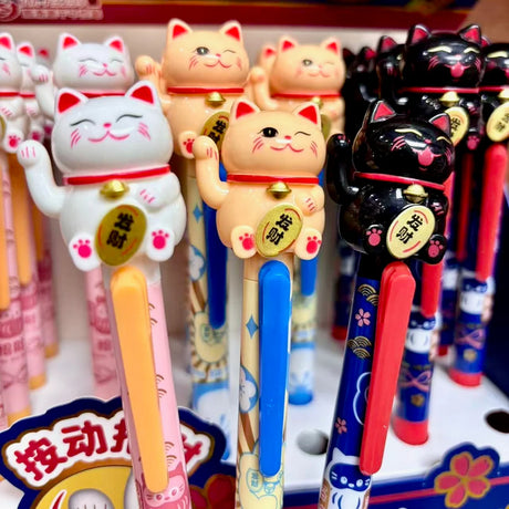 Bring a little good luck and a lot of cuteness to your writing routine with these pens! Each click makes the cat’s tiny paw&nbsp;move, adding a playful surprise every time you write. Smooth black gel ink and an adorable design make this pen a must‑have for stationery lovers and cat fans alike.

• Black Ink
• Writes very smoothly
• Measures approx. 6" - 7"
• Includes 1 pen, we will send one random color/design