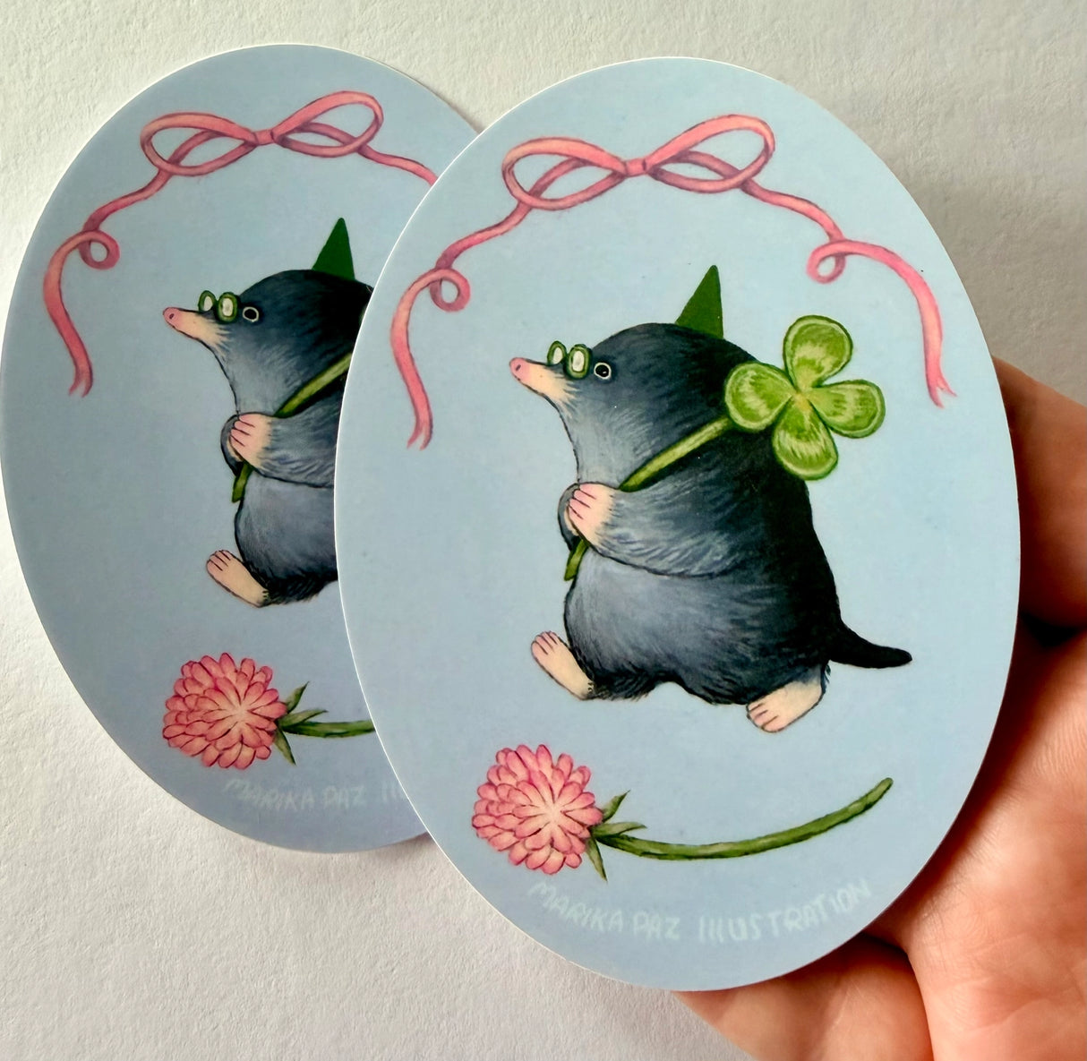 A very lucky mole takes their four-leaf clover home.

This vinyl matte sticker is weather and waterproof-stick it on a notebook, bike, or car- it's going to stick around! Heck, throw it on a water bottle and through the dishwasher. This sticker can go anywhere. Sticker measures 3.25" x 4.5" Printed in USA.