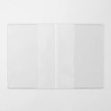 A transparent cover that fits snugly around your MD Notebook

This is a special cover that gently wraps your MD Notebook. The transparent cover protects the notebook from dirt without ruining its appearance.
It subtly protects your notebook from water and dirt without interfering with its characteristics. If you put the cover on with the glassine paper still wrapped around it, the inorganic feel of the vinyl will be softened.
Because it is transparent, you can enjoy the cover design, illustrations, and writ