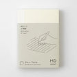 Crafted in Japan, this minimalist notebook is designed to enhance your writing experience. Inside, you'll find the high-quality Midori Diary (MD) paper, first developed in 1960 and refined ever since. Midori has rigorously tested this paper with various writing instruments to ensure quality, checking for ink feathering or bleeding, drying time, the smoothness of pen tips on the surface, and the tactile feel. The result is a paper that resists bleeding and feathering and is fountain-pen friendly, ensuring a 
