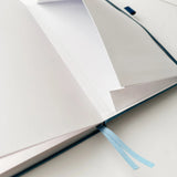 Jiji The Cat Journal in Ocean Blue with Holographic Edges and Logo 🌊✨

Product Details:

Size: A5 (5.70 x 8.26 inches)
160 Dotted Grid Pages (5 x 5 mm)
2 Bookmarks
Elastic Band and Pen Holder
Expandable storage compartment