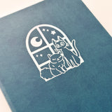 Jiji The Cat Journal in Ocean Blue with Holographic Edges and Logo 🌊✨

Product Details:

Size: A5 (5.70 x 8.26 inches)
160 Dotted Grid Pages (5 x 5 mm)
2 Bookmarks
Elastic Band and Pen Holder
Expandable storage compartment