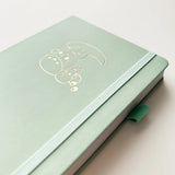 Bunny Spirit Journal in Sage Green with Gold Foil Logo🌱

Product Details:

Size: A5 (5.70 x 8.26 inches)
160 Dotted Grid Pages (5 x 5 mm)
2 Bookmarks
Elastic Band and Pen Holder
Expandable storage compartment