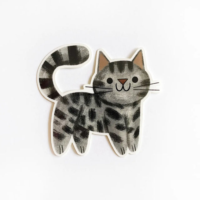 Wooden toy cat with black stripes on a white background