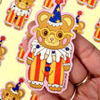 These adorable stickers feature a cute little bear in a clown suit.

These matte vinyl stickers feature an original design and are water, weather, and scratch proof. Perfect for putting on water bottles, computers or just about anywhere else.