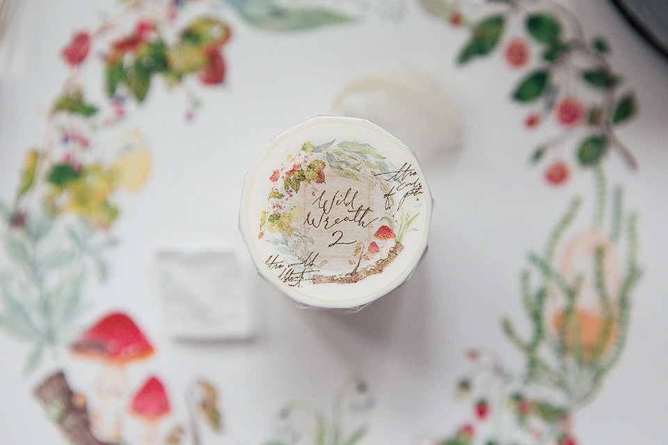 OURS Studio Wild Wreath 2 Washi Tape Decorative bottle cap with floral design and text on a floral-patterned background
