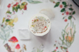 OURS Studio Wild Wreath 2 Washi Tape Decorative bottle cap with floral design and text on a floral-patterned background