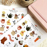 A matte paper sticker sheet filled with cozy, hand-drawn illustrations, perfect for planners, journals, or scrapbooking. It features a cozy spring and hygge season theme, making it a perfect fit for mindful living enthusiasts. All designs are lovingly created by Monika Szczerbińska.