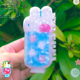 'Soda Float' Hair Claw featuring a blue soda float with rabbit shaped ice cream on top.

Made of acetate, 4 inches by 2 inches.

Hair claws come packaged in a plastic sleeve.