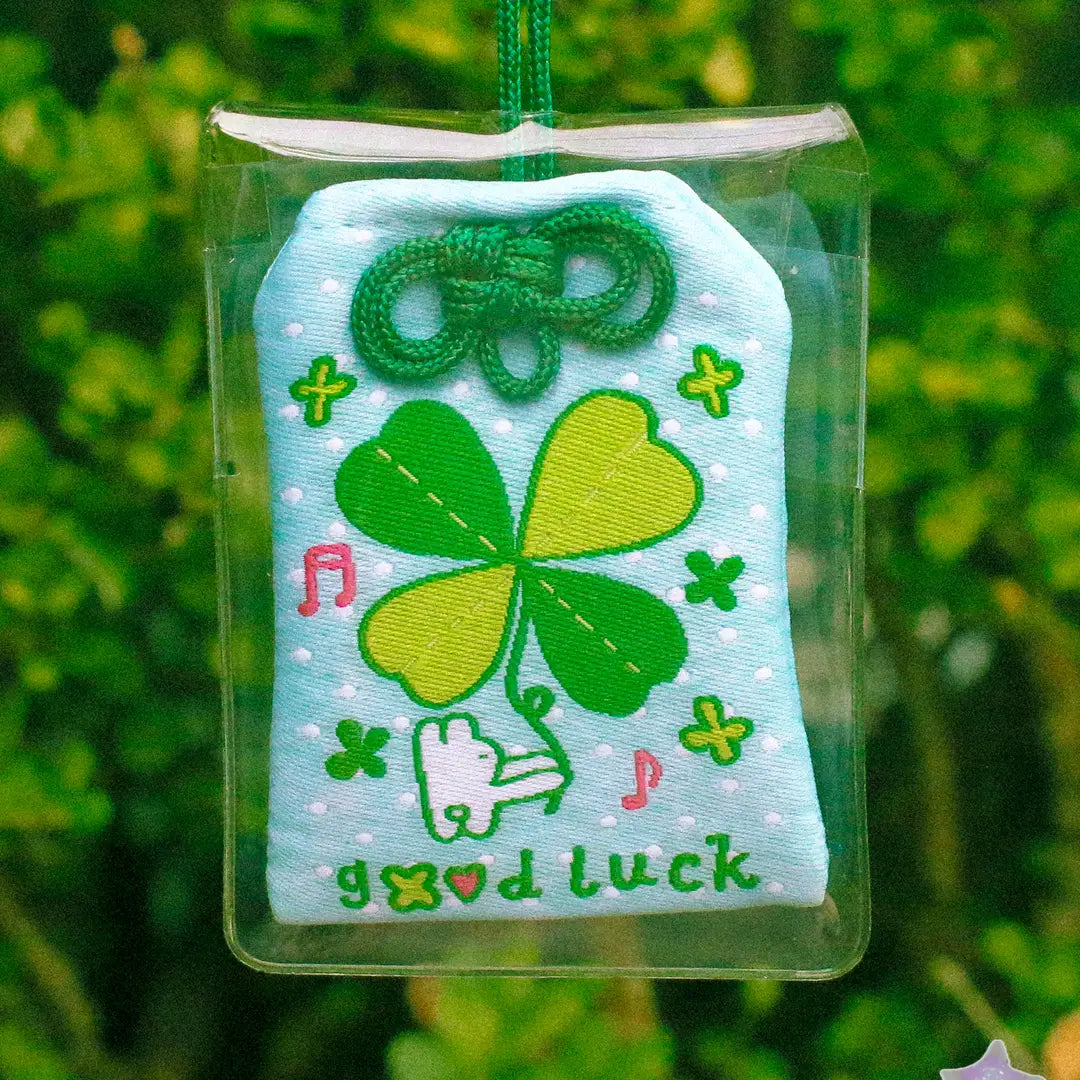 2x2.5 omamori charm with a 8 inch string.

An omamori is a Japanese charm that provides protection and luck!