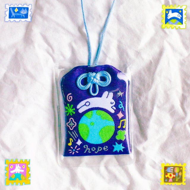 2x2.5 omamori charm with a 8 inch string.

An omamori is a Japanese charm that provides protection and luck!