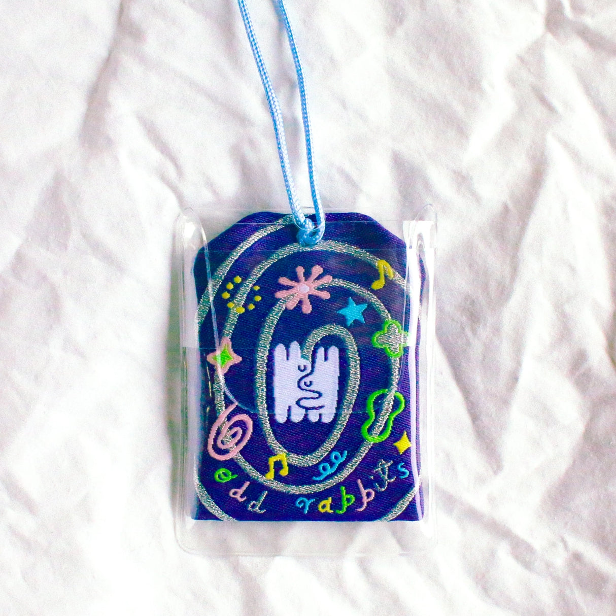 2x2.5 omamori charm with a 8 inch string.

An omamori is a Japanese charm that provides protection and luck!