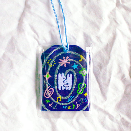 2x2.5 omamori charm with a 8 inch string.

An omamori is a Japanese charm that provides protection and luck!
