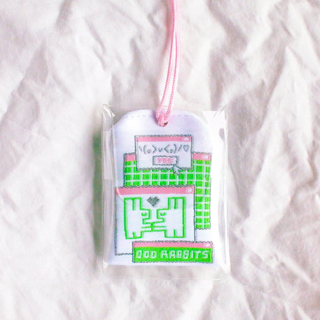 2x2.5 omamori charm with a 8 inch string.

An omamori is a Japanese charm that provides protection and luck!