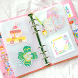 This is a A6 six ring binder that measures 14 cm x 19 cm when closed! It includes interior pockets for extra storage and a hole on the spine for charms.

This binder is great for storing stickers, sticker packs, note cards, photo cards, pet tape loops, ephemera and small sticker sheets. They can also be filled with paper and used as a notebook or journal.
