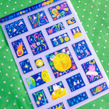 'To the Moon &amp; Back' Frosted Glitter Transparent A6 Sticker Sheet. Stickers are stamp shaped and have a clear blue background.

Not waterproof.
Do not place in areas of high wear (laptops, phone cases, water bottles, etc).
Sticker sheets come packaged in a plastic sleeve.