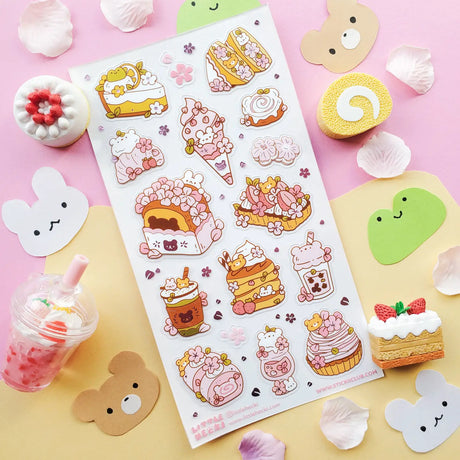 🌸🍰 Welcome springtime sweetness! This adorable sheet by @littlehecki is bursting with sakura magic and yummy café treats. From fluffy shortcakes and swirly cream rolls to dreamy parfaits, sakura cupcakes, and pastel milk teas, every dessert feels kissed by cherry blossoms. It’s like a cherry blossom picnic in sticker form — petals drifting through the air, sunshine on your cheeks, and sweet seasonal treats all around.

Art by: @littlehecki

Top Coating: None
Adhesive Layer: PVC (plastic)
Backing Layer: Cl